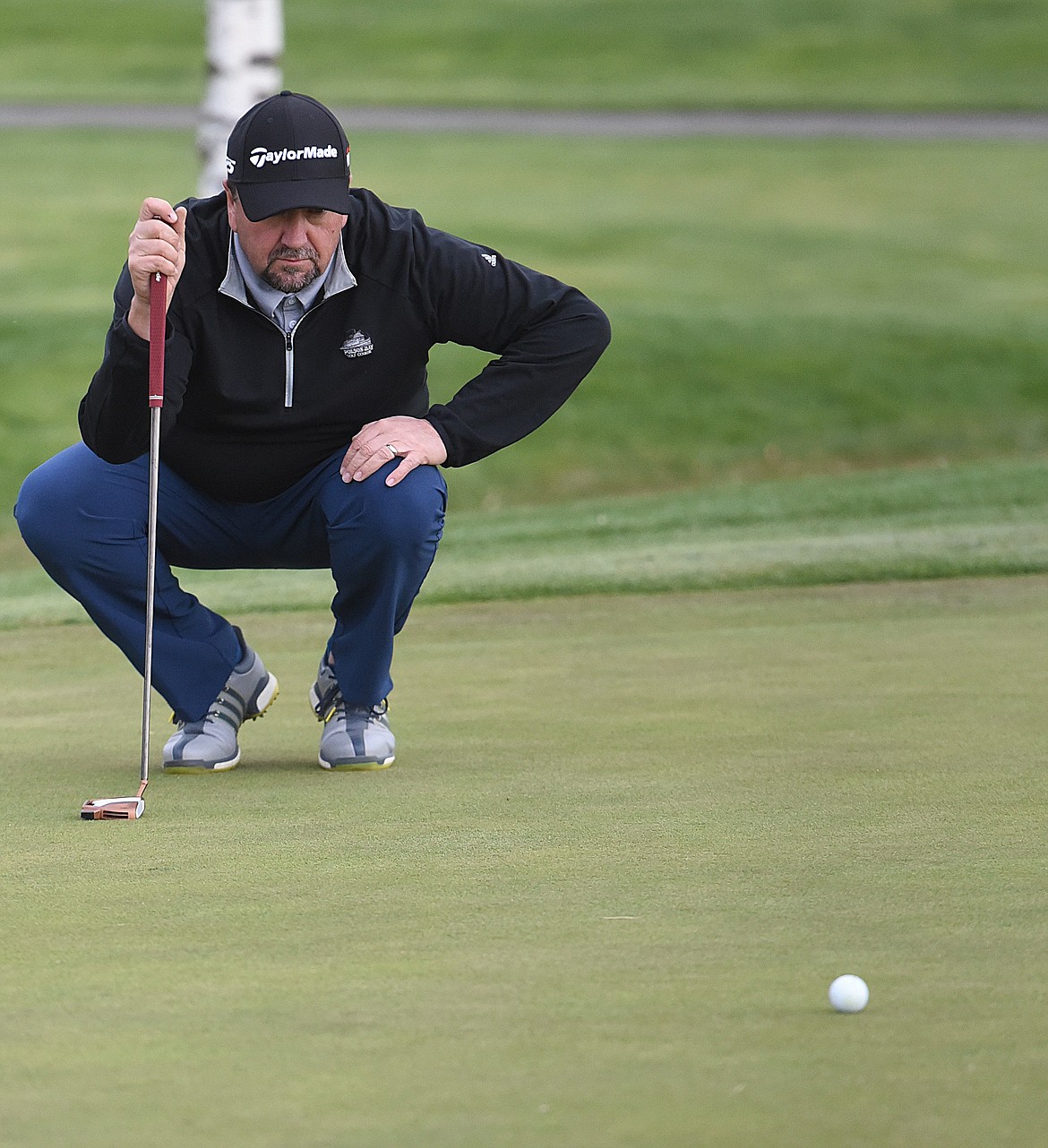 ROGER WALLACE reads the green before an important putt during the Lake City Open. Wallace, playing his home course, had rounds of 69 and 75 for a 144 to win the Senior Pro title. (Joe Sova/Lake County Leader)