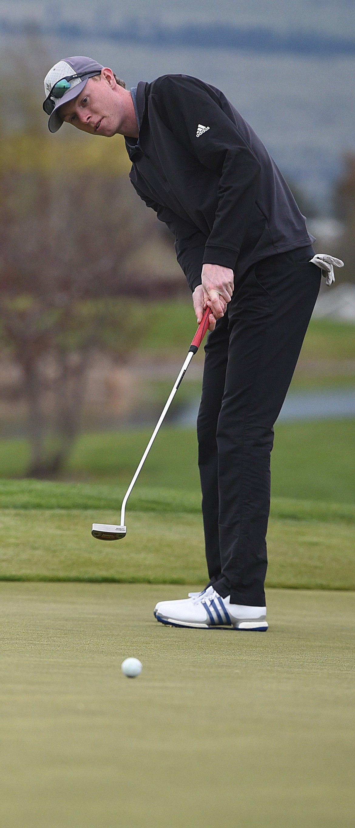 RYGGS JOHNSTON of Libby rolls a putt toward the hole Sunday during the Lake City Open. He led the amateurs with a sparkling 67 Saturday, but struggled Sunday with a 75 for a 142 total, tying for third place.