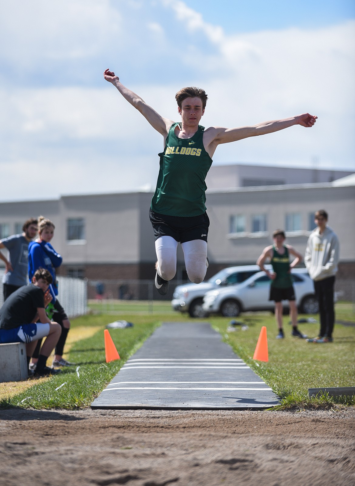 Bodie Smith skies for the triple jump at Columbia Falls last Tuesday. (Daniel McKay/Whitefish Pilot)