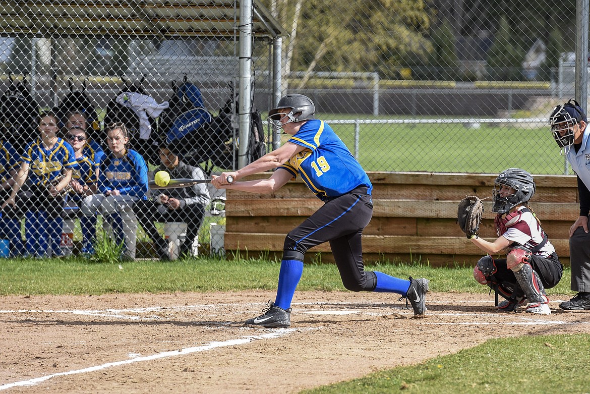 Libby sophomore Taylor Holm reaches in to make contact, hitting a homerun over the centerfield fence, top of the fourth, bringing in 3 runs for Libby, during the Libby-Troy varsity game at Troy, April 30. (Ben Kibbey/The Western News)