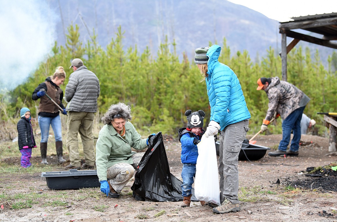 Irina  Moore, left to right, Connor Reed, 2, and Jessica Bousquet of Kalispell share a laugh as they help with the Hunt Montana cleanup effort on Saturday morning, April 27, in the Flathead National Forest. A few of the volunteers brought along their children to help teach them about &#147;leave no trace&#148; and the importance of taking care of natural resources.
(Brenda Ahearn/Daily Inter Lake)