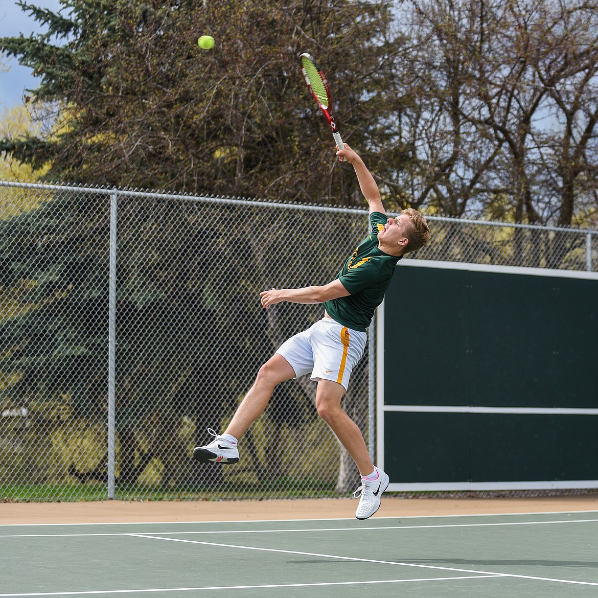 Mark Anderson reaches high during a match against Libby on Saturday. (Daniel McKay/Whitefish Pilot)