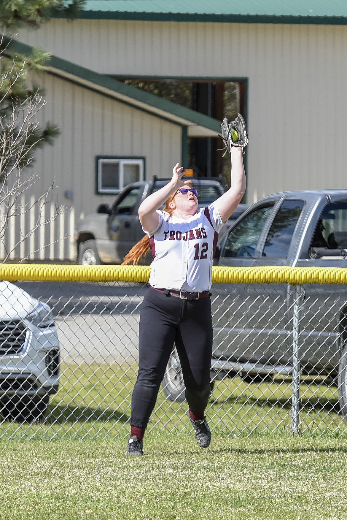Troy junior left fielder Montana Rice catches the final out, top of the second inning, during the Troy-Libby varsity game at Troy, April 30. (Ben Kibbey/The Western News)