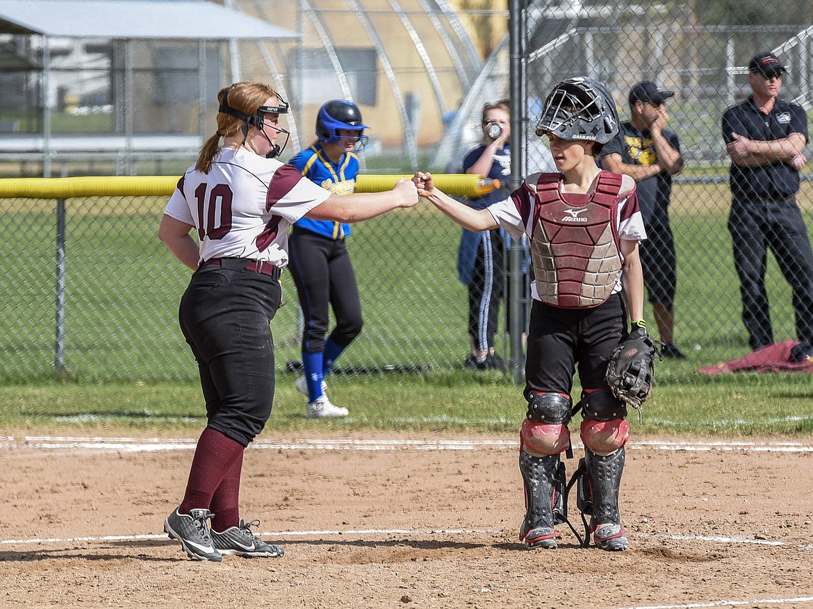 Troy junior pitcher Mazzy Hermes and senior catcher Kaylee Tunison exchange a fist bump after a short talk on the mound, top of the third inning with one out and a hit-by-pitch walk, during the Troy-Libby varsity game at Troy, April 30. (Ben Kibbey/The Western News)