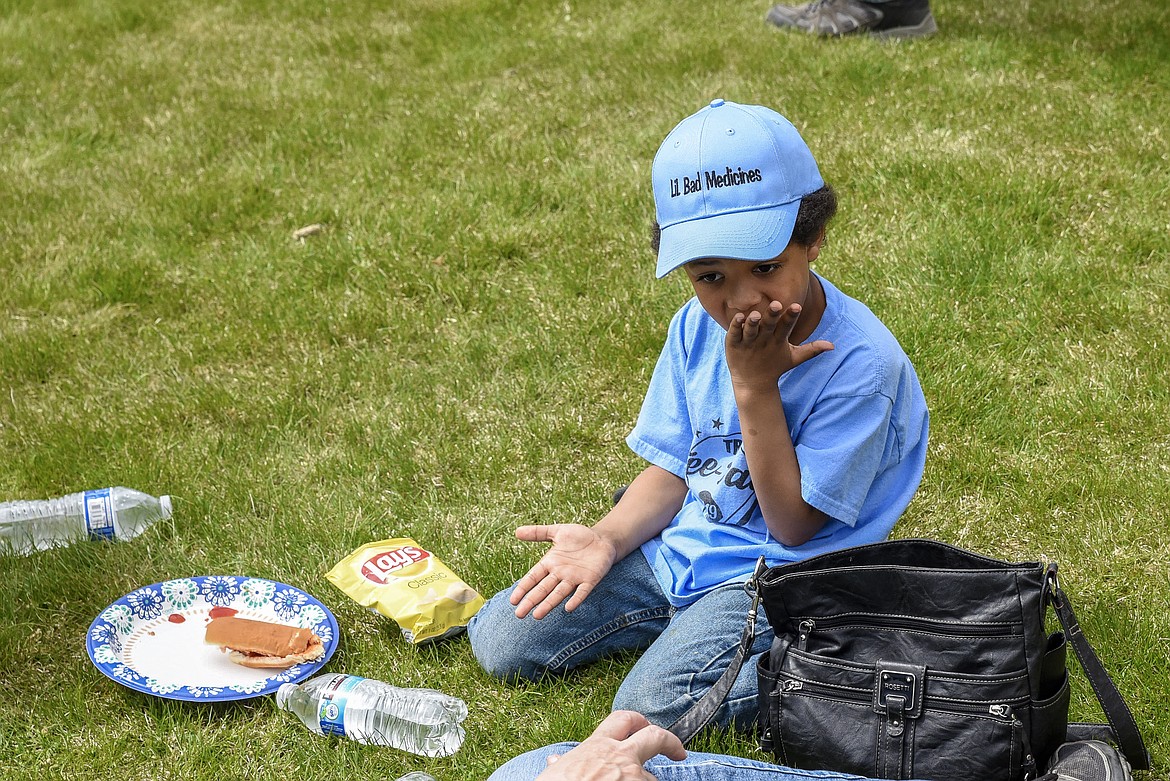 Lovell Dolezal cleans up after his hotdog bun fell apart on him, during activities at Roosevelt Park following the Opening Day Parade in Troy, Saturday. (Ben Kibbey/The Western News)