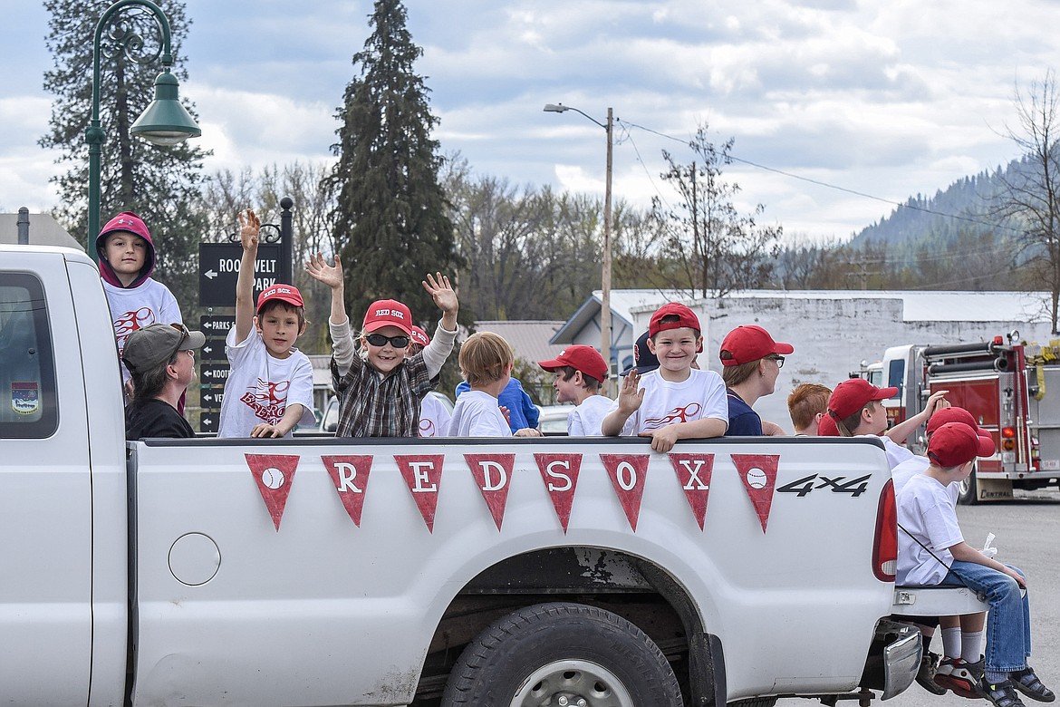 The Red Sox wave a hearty &#147;hello&#148; on their way to Riverfront Park during the the Opening Day Parade in Troy, Saturday. (Ben Kibbey/The Western News)