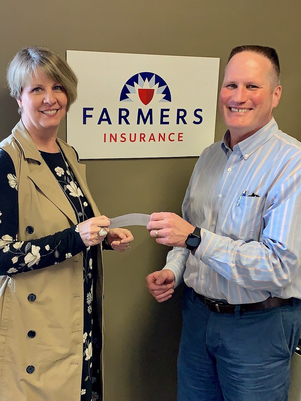 Courtesy photo
Sally Hendricks-Bauer, representing Farmers Insurance, donates $500 to Bonners Ferry Mayor David Sims to help pay for children&#146;s season passes to the city swimming pool.