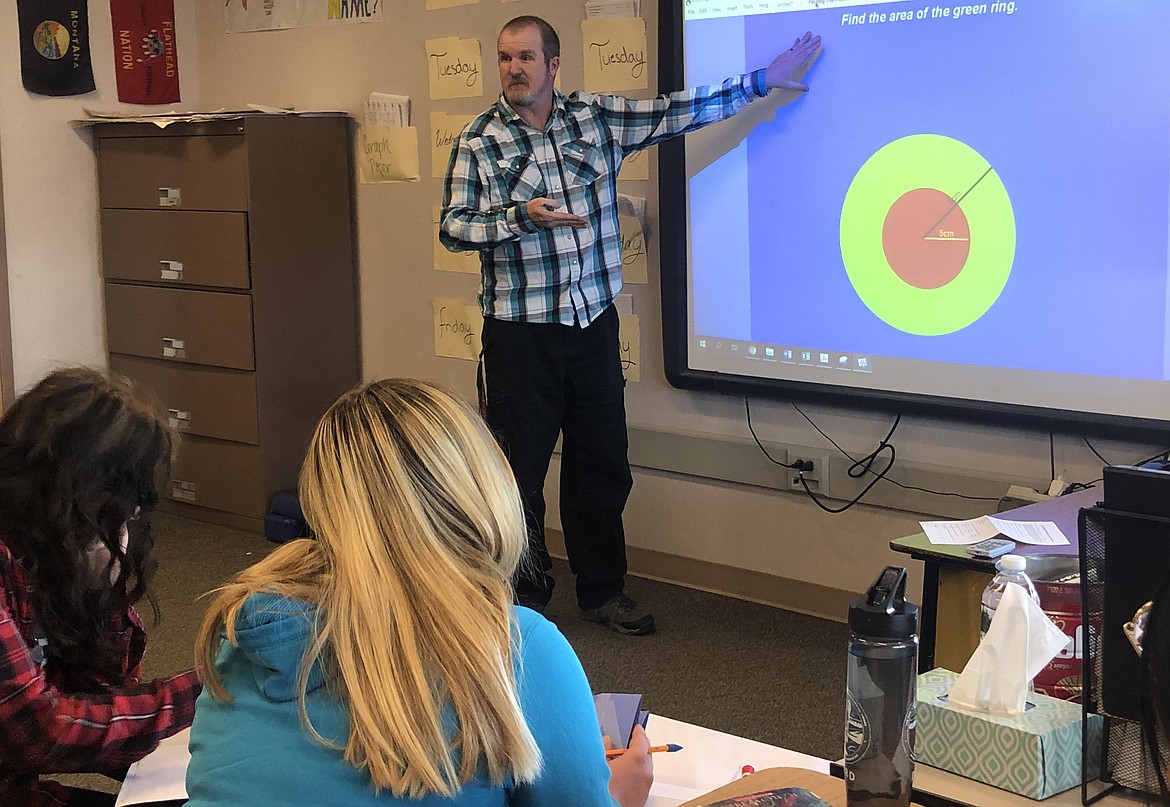 RONAN MIDDLE School math teacher William Becker uses his white board for a demonstration to students in his classroom Tuesday. Becker finished in the top 30 nationwide in a Norwegian Cruise Line contest. (Lexi Gauthier/ Lake County Leader)