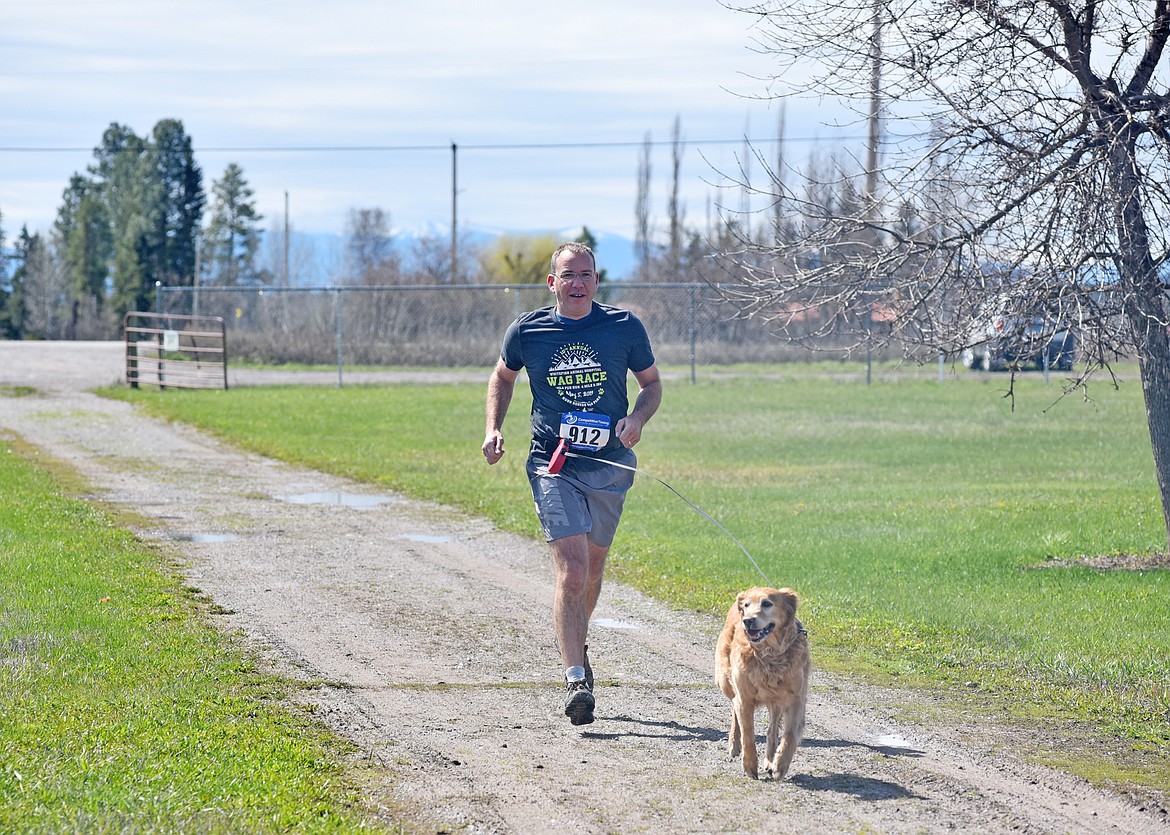 Dave Boye and his dog near the finish of the 10th annual WAG Race Sunday morning at the WAG dog park.  (Heidi Desch/Whitefish Pilot)