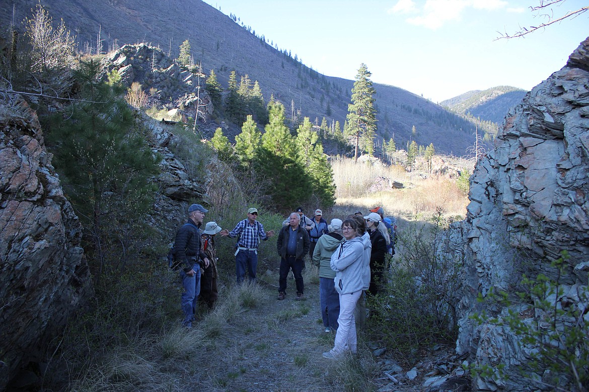 Hikers stop for a history lesson about the Mullan Road. Mullan&#146;s crews blasted the rock with dynamite to build the first military road through the Rockies in 1859. (Maggie Dresser/Mineral Independent)