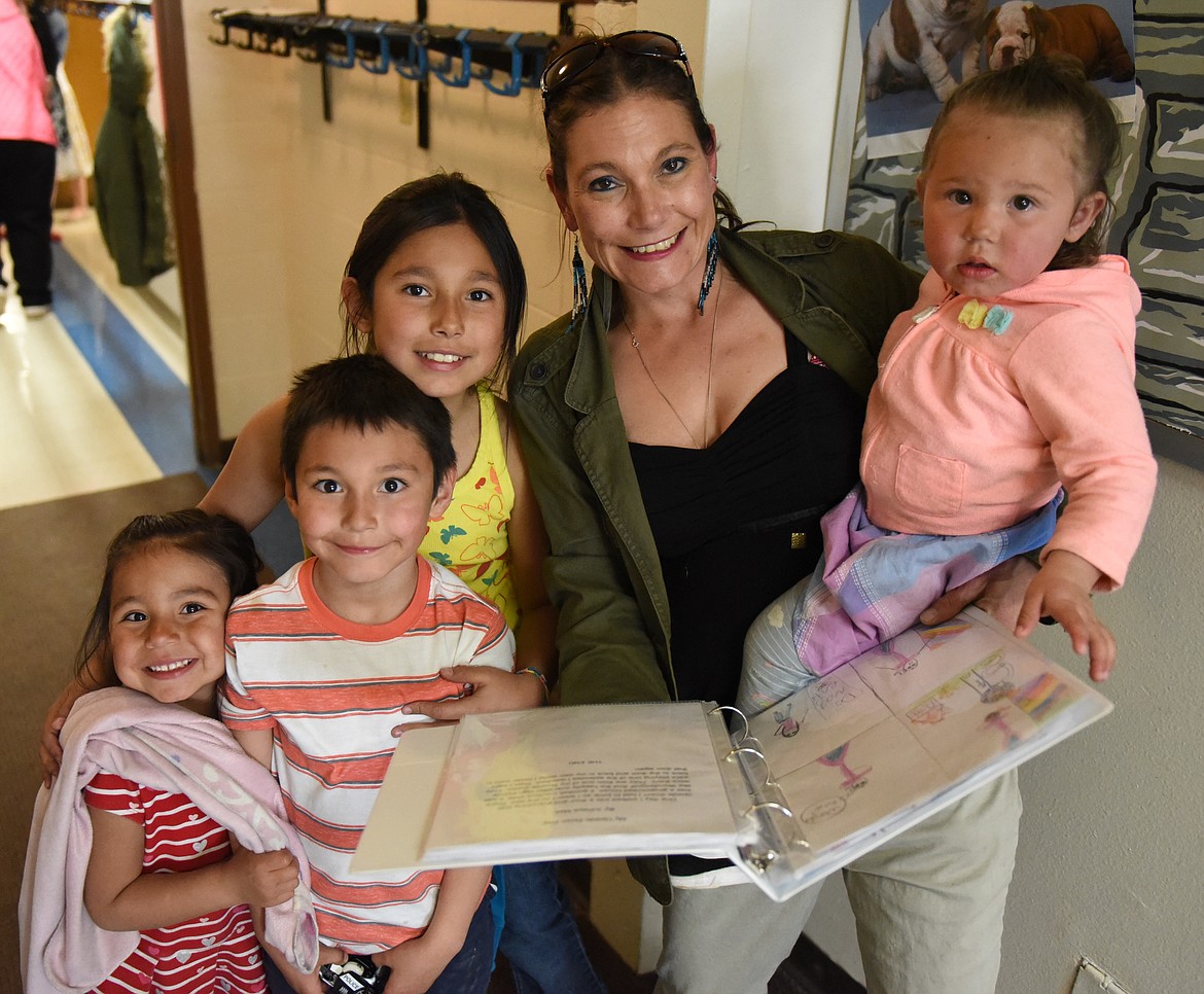 FOUR-YEAR-OLD JuDaya Matt, in yellow, shared the &#147;Writing Portfolio&#148; on Thursday, April 25 that she made with her mother, Crystal Azure, and from left, her siblings Olivia Teigen, Isayah Matt and Rebecca Teigen. (Joe Sova photos/Lake County Leader)