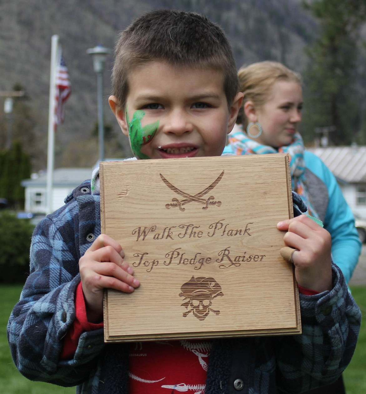 SIX-YEAR-OLD Eli Blekkenk holds his plaque after raising the most money at the fundraiser with $1,060 collected.