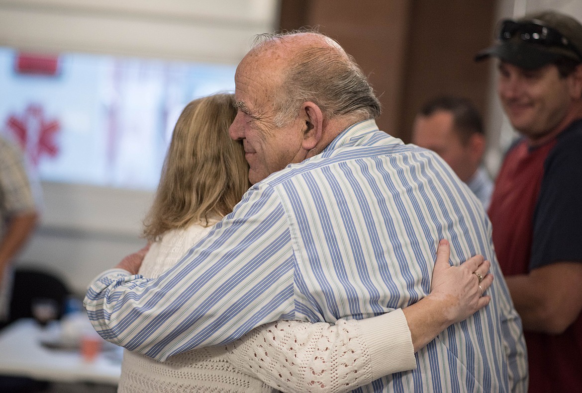 Penny Kyes, left, embraces her father after receiving an award for 25 years of Libby Volunteer Ambulance service, Saturday. (Luke Hollister/The Western News)