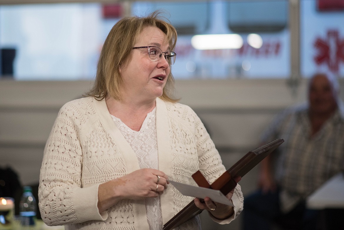 Penny Kyes receives an award for 25 years of Libby Volunteer Ambulance service with personalized thank you card, Saturday. (Luke Hollister/The Western News)