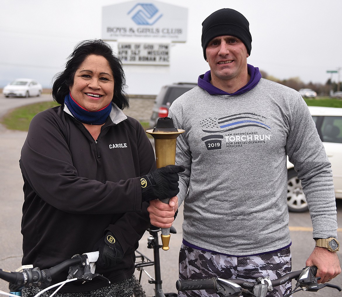 CAROLE LANKFORD, left, and Brandon Couture rode their bicycles from Pablo to Ronan last Friday as co-torch bearers during the Law Enforcement Torch Run for Special Olympics. Lankford is a member of the Confederated Salish and Kootenai Tribal Council, and Couture is a sergeant and investigator for Tribal Fish and Game.