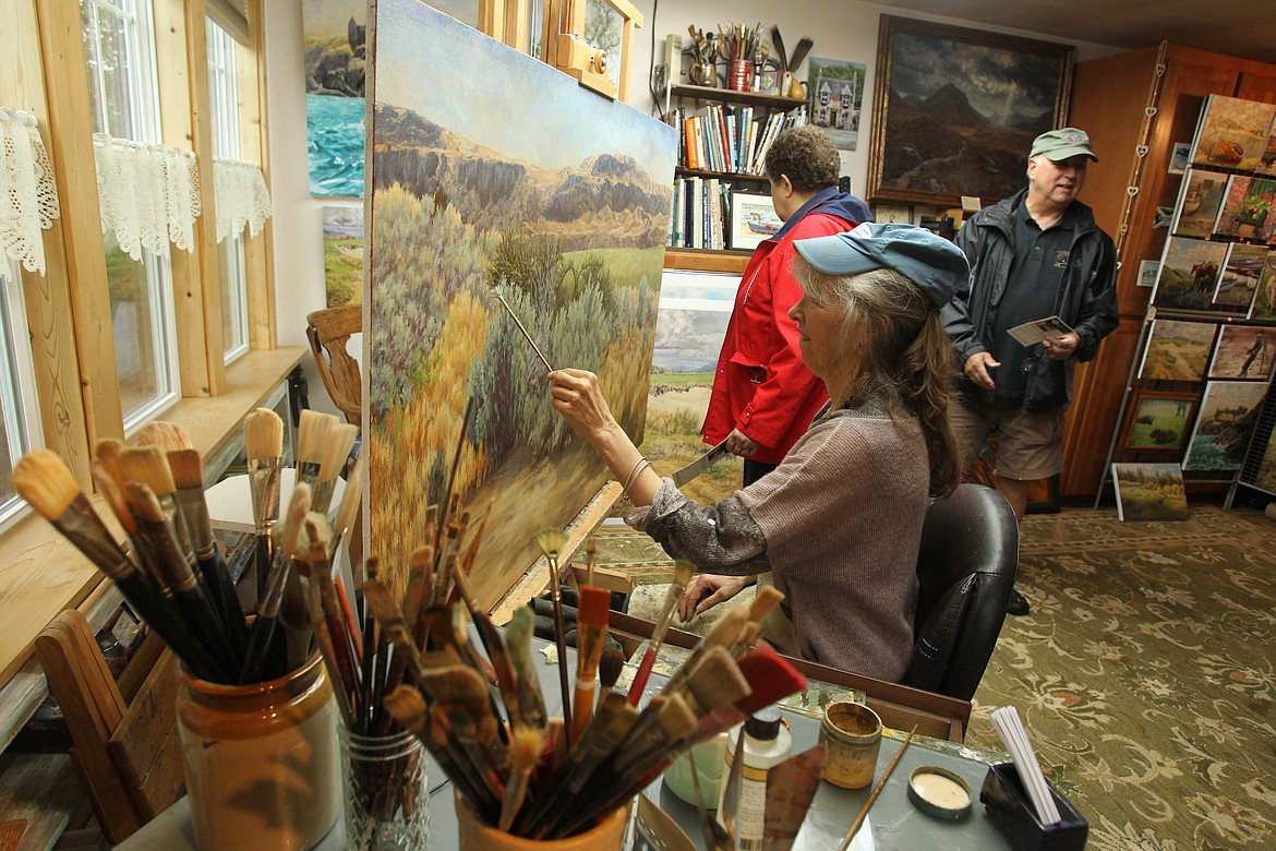 DEVIN WEEKS/Press
Oil painter Jan Clizer adds to a large commissioned painting she is working on as people browse her works on display in her studio 2018 Coeur d&#146;Alene Artists Studio Tour, presented by the Coeur d&#146;Alene Arts and Culture Alliance. This year&#146;s studio tour is June 8 and 9 with artists&#146; works on display in the Human Rights Education Institute through June 3 and a preview reception May 31.