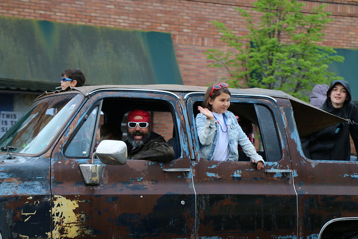 (Photo by CAROLINE LOBSINGER)A classic truck driver and his crew have fun during Friday's Lost in the &#146;50s parade.