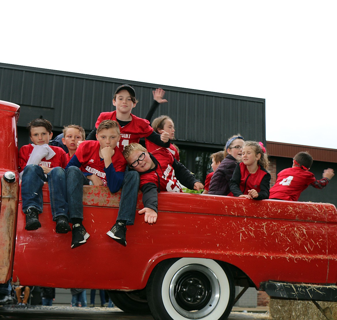 (Photo by CAROLINE LOBSINGER)
Youngsters pose for the camera as they ride in a classic truck during Friday&#146;s Lost in the &#145;50s. parade.