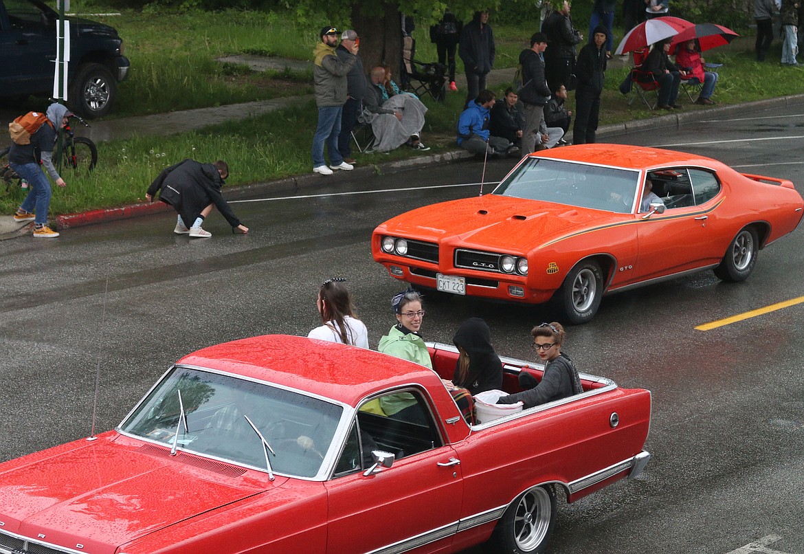 (Photo by MARY MALONE)A group of parade participants have fun as they catch a ride during Friday's Lost in the &#146;50s parade.