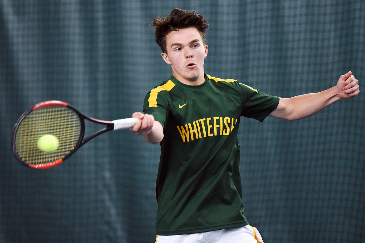 Whitefish's Brendan Buls hits a return against Polson's Joe McDonald in the Northwestern A Divisional boys' singles championship at The Summit on Friday. (Casey Kreider/Daily Inter Lake)