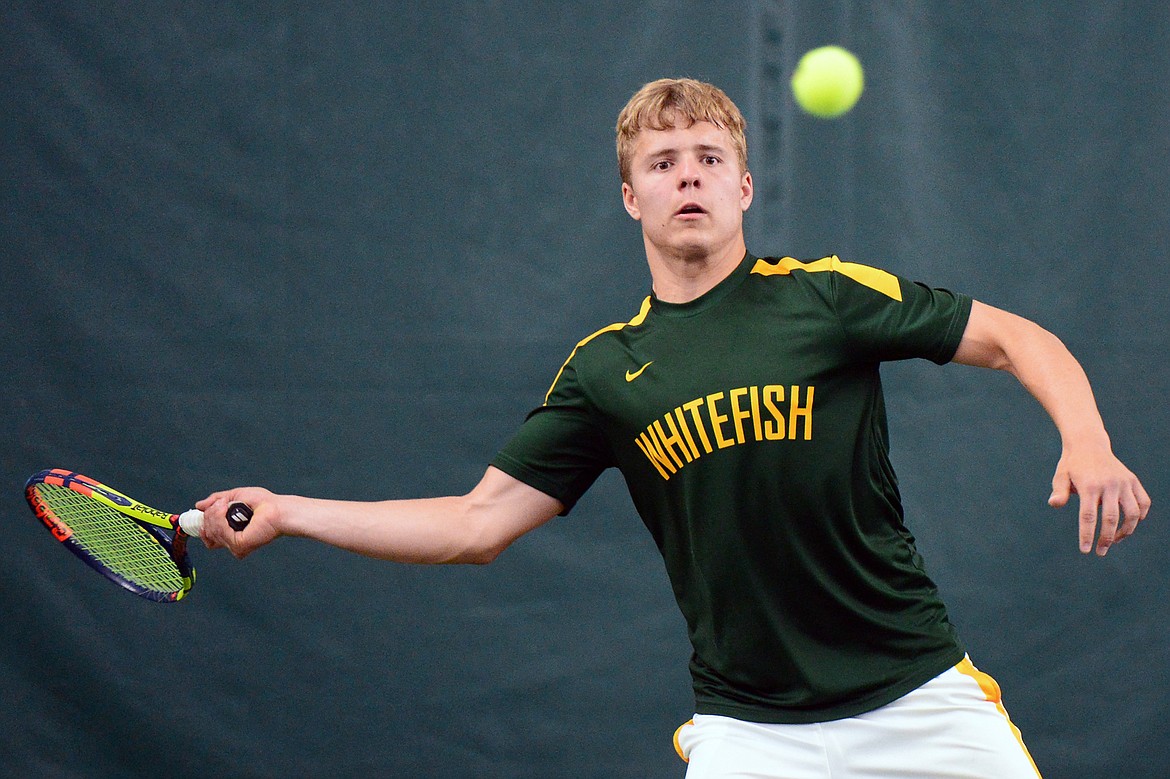 Whitefish's Mark Anderson hits a return with teammate Colter Upton in the Northwestern A Divisional boys' doubles championship with against Columbia Falls' John Gilk and Camryn Lingle at The Summit on Friday. (Casey Kreider/Daily Inter Lake)