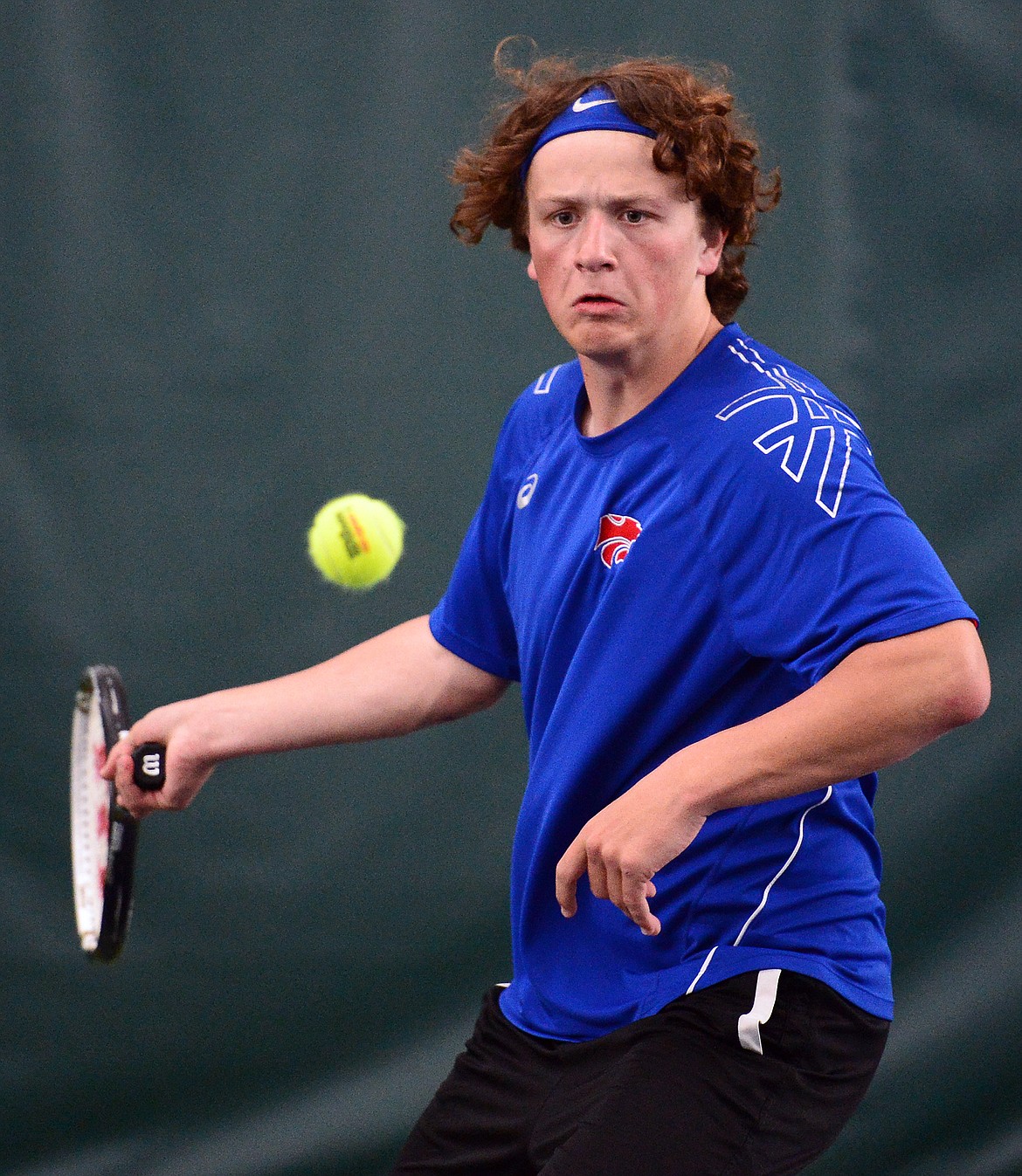 Columbia Falls' Camryn Lingle hits a return in the Northwestern A Divisional boys' doubles championship with teammate John Gilk against Whitefish's Mark Anderson and Colter Upton at The Summit on Friday. (Casey Kreider/Daily Inter Lake)