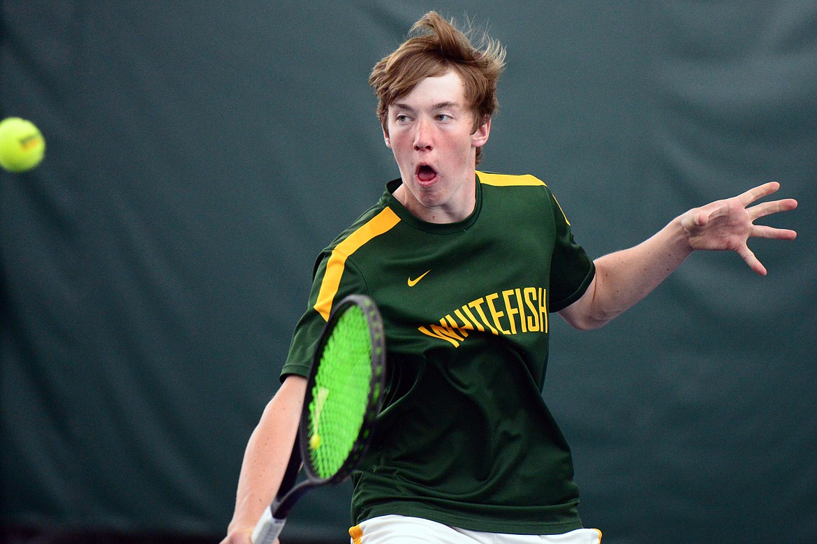 Whitefish's Colter Upton hits a return in the Northwestern A Divisional boys' doubles championship with teammate Mark Anderson against Columbia Falls' John Gilk and Camryn Lingle at The Summit on Friday. (Casey Kreider/Daily Inter Lake)