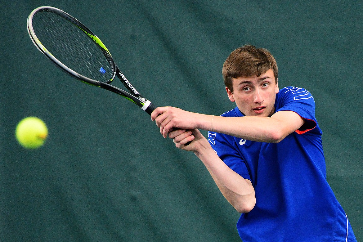 Columbia Falls' John Gilk hits a return with teammate Camryn Lingle in the Northwestern A Divisional boys' doubles championship against Whitefish's Mark Anderson and Colter Upton at The Summit on Friday. (Casey Kreider/Daily Inter Lake)
