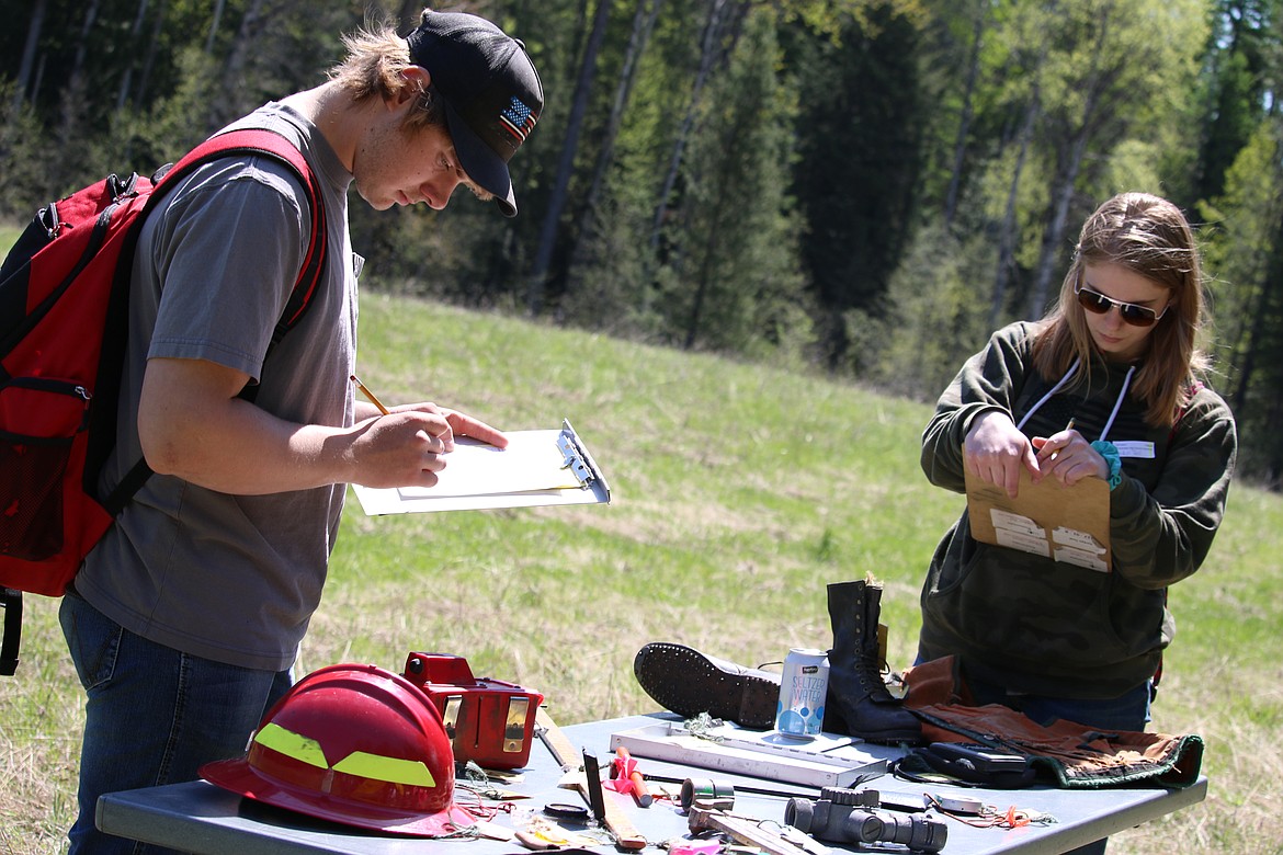 (Photo by MARY MALONE)
Priest River Lamanna High School student Colton McDonald, left, and Timberlake High School junior Jordyn Teal, right, were among the 700 North Idaho youth who participated in the Idaho State Forestry Contest last Thursday at Delay Farms in Careywood. Tool identification was one of eight stations participants in the junior and senior division were tested on.