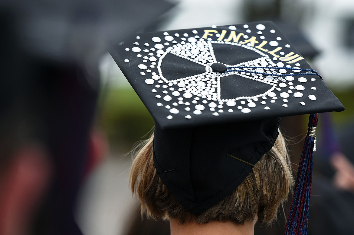 A graduate with a decorative message on her mortarboard files across campus during Flathead Valley Community College's 51st class commencement ceremony on Friday. (Casey Kreider/Daily Inter Lake)