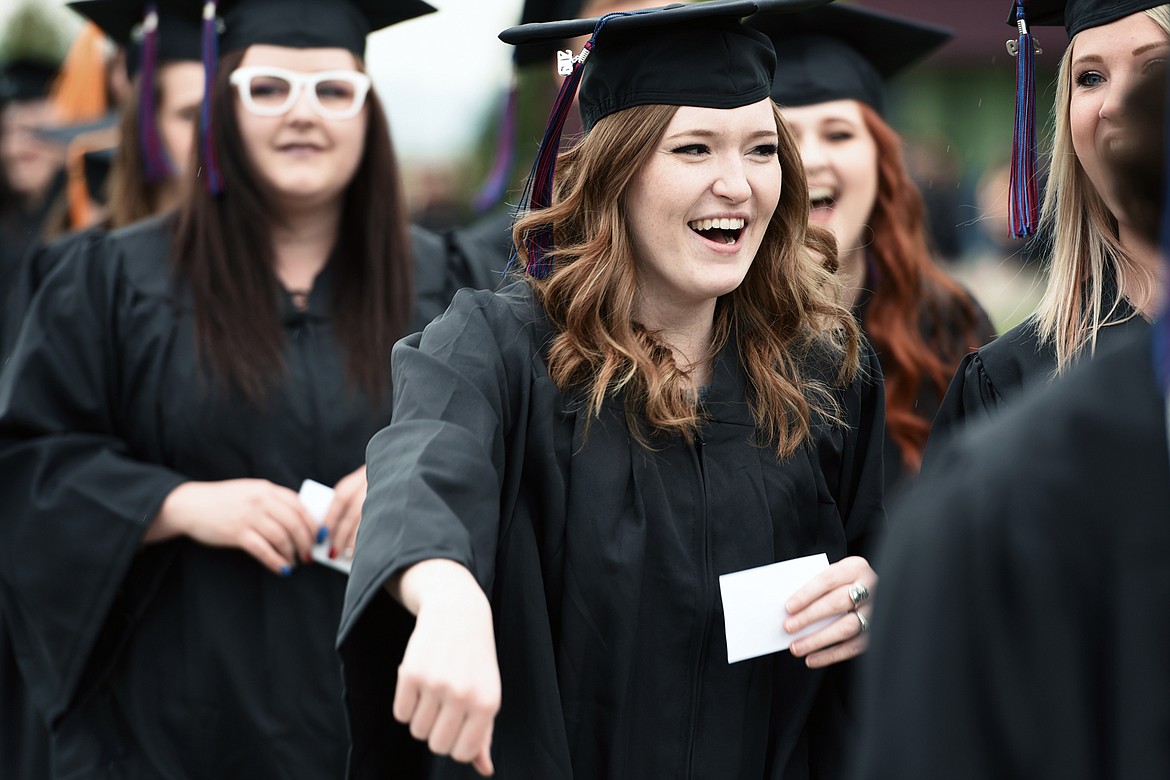 Graduates are all smiles as they walk across campus during Flathead Valley Community College's 51st class commencement ceremony on Friday. (Casey Kreider/Daily Inter Lake)