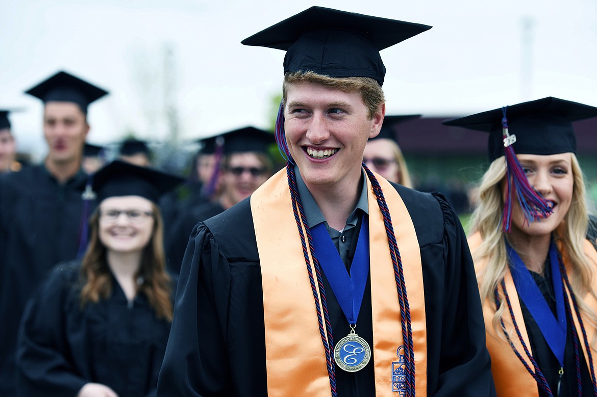 Graduates are all smiles as they walk across campus during Flathead Valley Community College's 51st class commencement ceremony on Friday. (Casey Kreider/Daily Inter Lake)