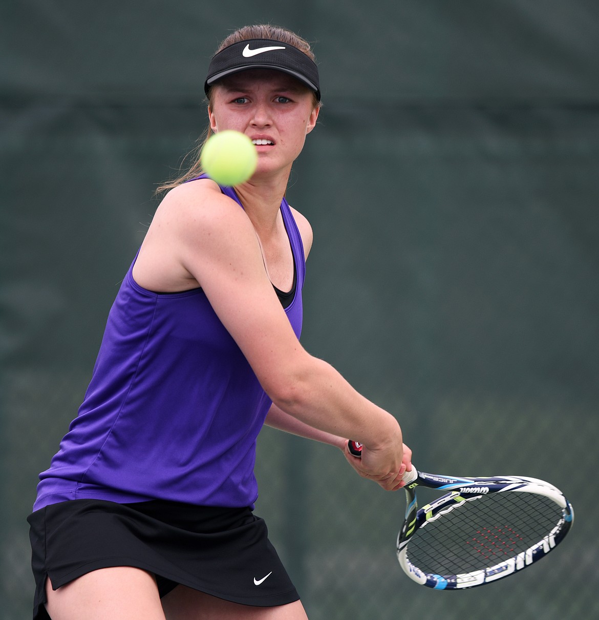 Shea McGuinness of Polson eyes her return during singles play at the Northwestern A Divisional tennis tournament on Thursday at Flathead Valley Community College. (Casey Kreider/Daily Inter Lake)