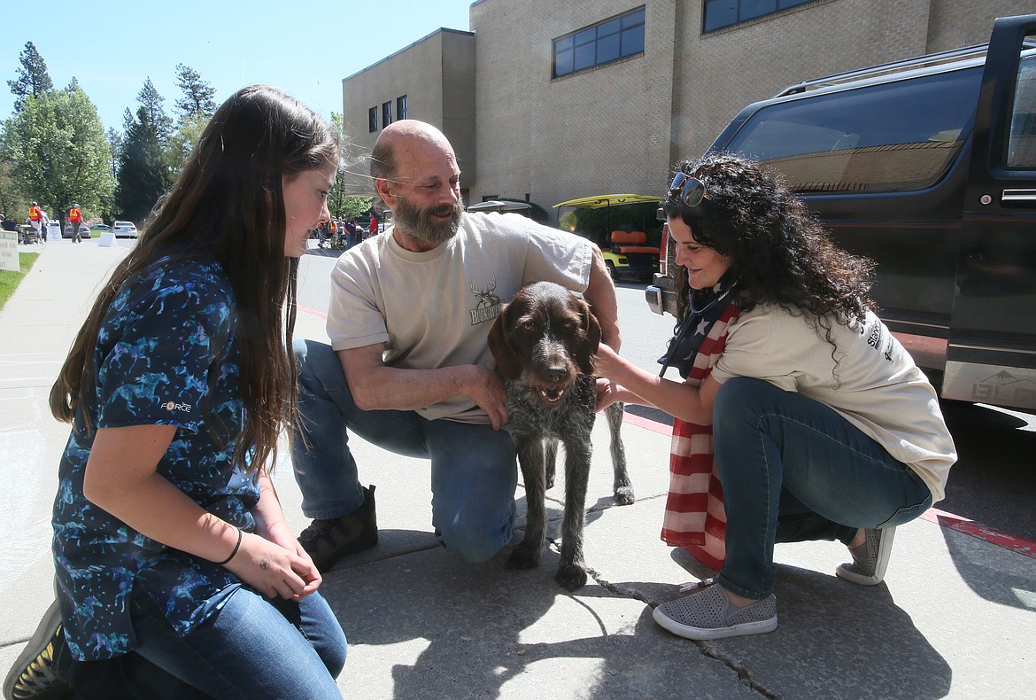 Photos by DEVIN WEEKS/Press
Dr. Amber Clark of Doc Holly Pet Vet in Hayden, with help from her daughter, Ella, 12, checks on Coeur d&#146;Alene Navy veteran Mike Stevenson&#146;s dog Anise during the North Idaho Veterans Stand Down at North Idaho College on Saturday.