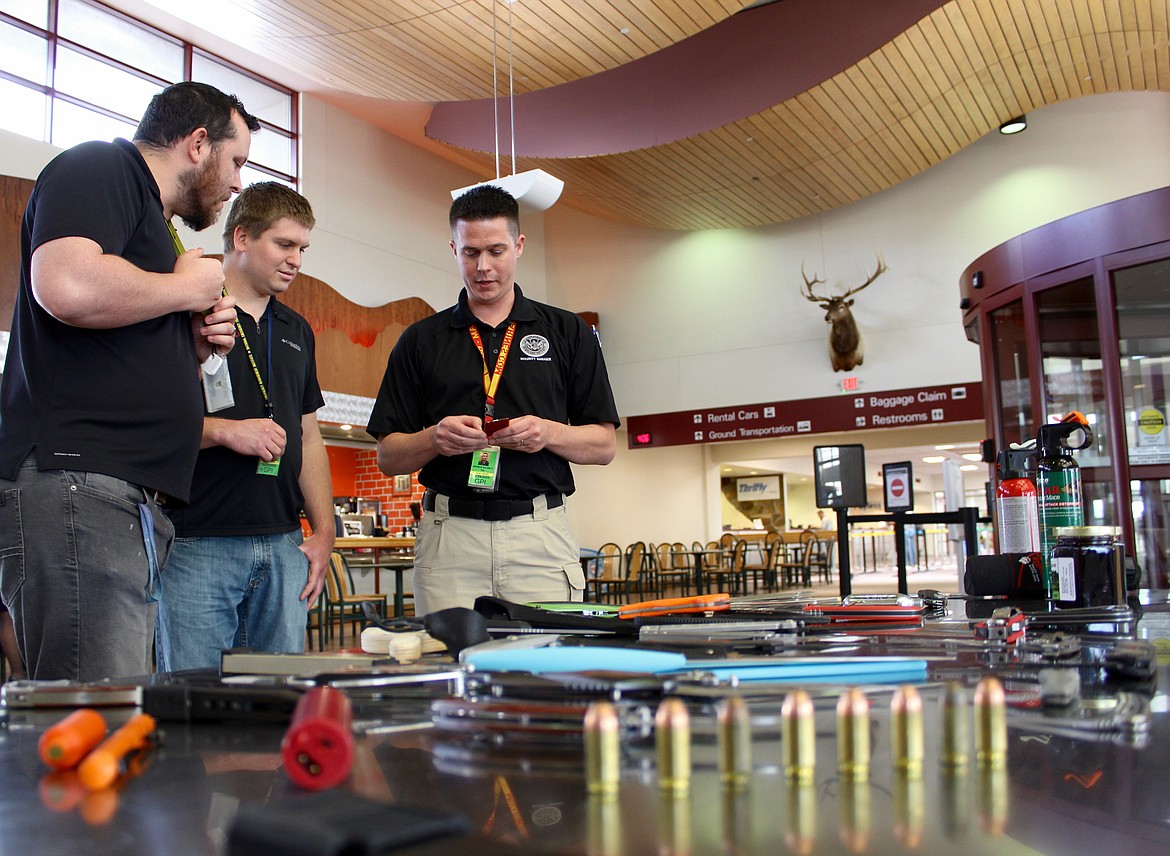 Security manager at Glacier Park International Airport, Derrick Salmela (right), shows a credit card-sized knife tool that was recently confiscated from carry on luggage. (Kianna Gardner/Daily Inter Lake)