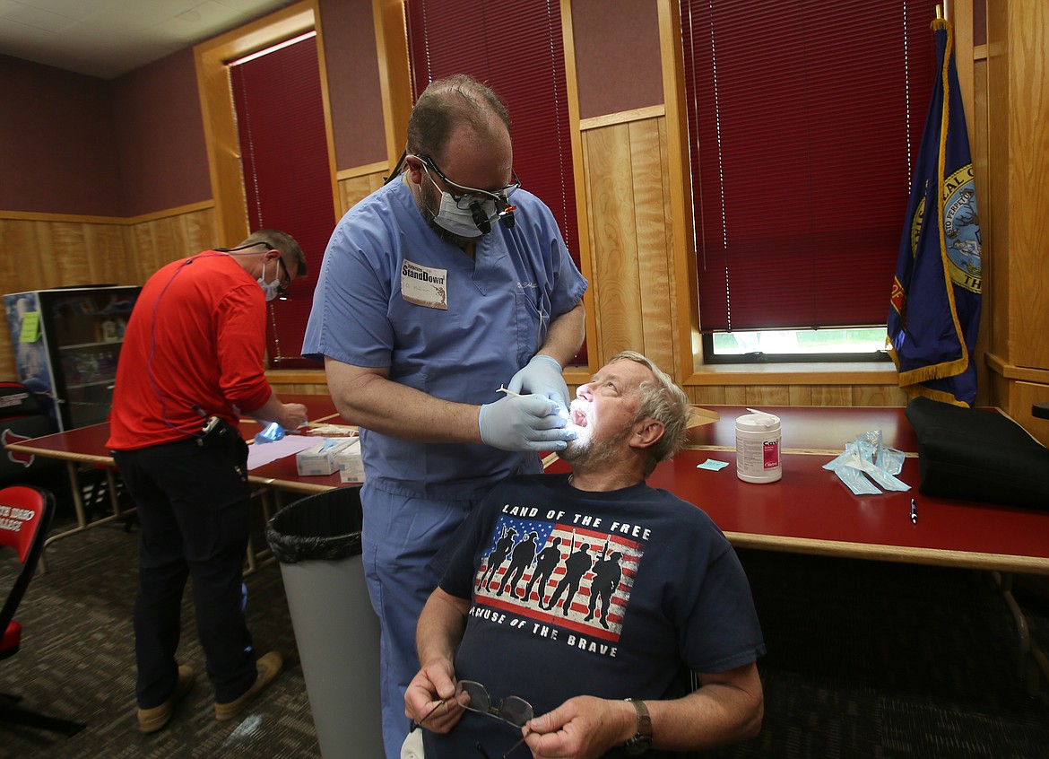 Army veteran Rich Peterson receives complimentary dental attention from Dr. Brett Matteson of Lakeview Dental Clinic at North Idaho College on Saturday during the North Idaho Veterans Stand Down.