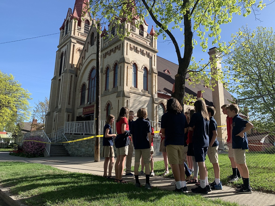 A group of St. Matthew&#146;s School seventh-graders in Doug Manaker&#146;s religious studies class gather outside the church to recite the rosary on Monday, May 13. (Hilary Matheson/Daily Inter Lake)