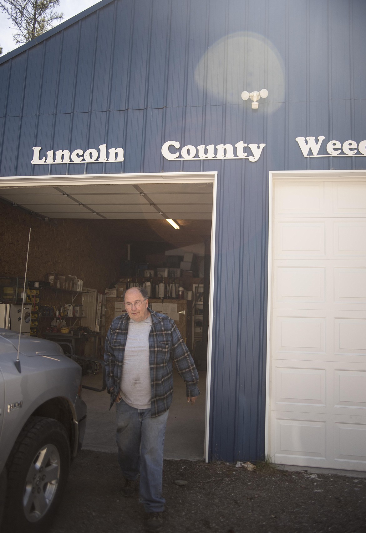 Dan Williams, Lincoln County Weed Department head, walking around the Weed Department shop before heading out April 30 in Libby. (Luke Hollister/The Western News)