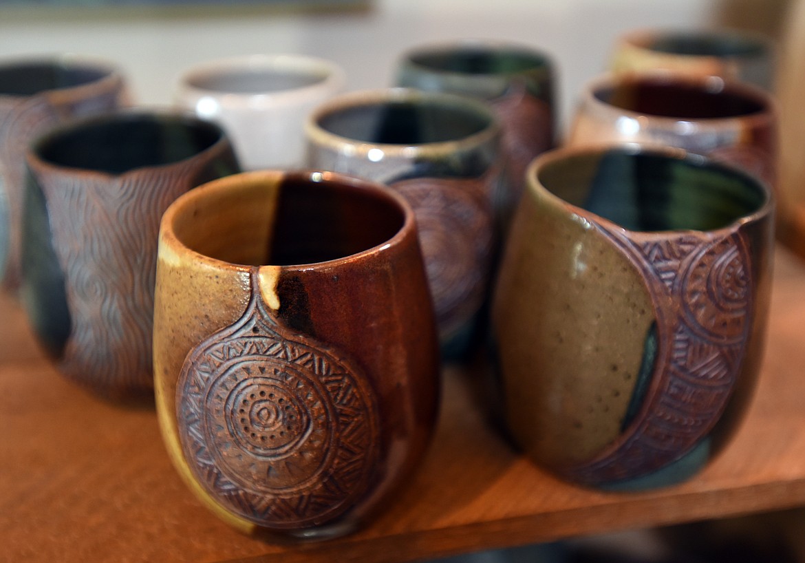 A collection of carved, glazed and fired mugs for sale at Glacier Round House Pottery.(Brenda Ahearn/Daily Inter Lake)