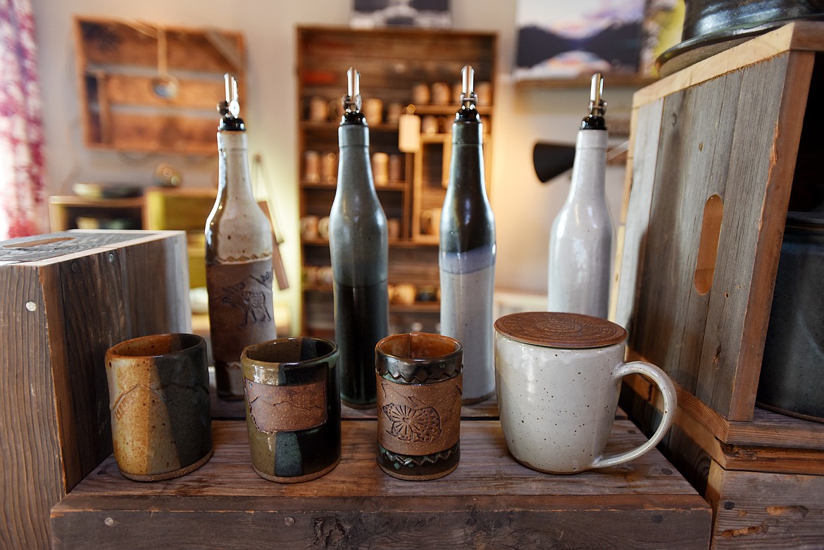 A collection of cups, olive oil bottles and other pottery pieces fill the shop at Glacier Round House Pottery.