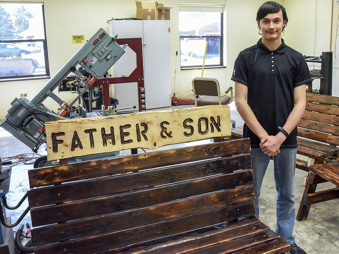 Troy Freshman Dominic Bell stands next to the bench he made in Jeff Thill&#146;s class with the inspiration of using the project to connect with his father. (Ben Kibbey/The Western News)