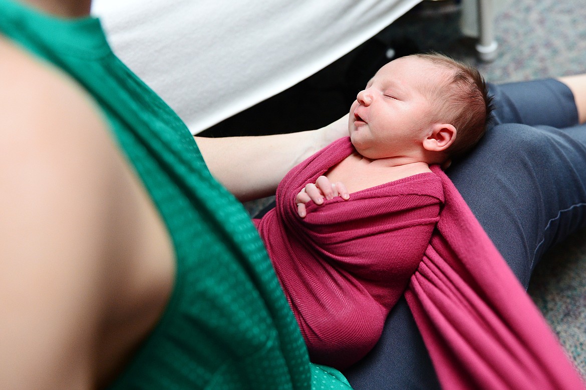 Photographer Dianne Dotter positions a newborn baby inside a decorative wrap during a session at Kalispell Regional Medical Center on Tuesday, May 7. (Casey Kreider/Daily Inter Lake)