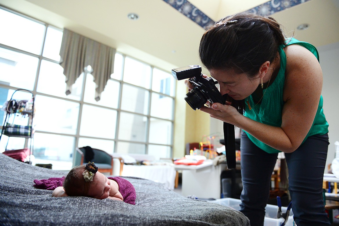 Photographer Dianne Dotter works with a newborn baby during a session at Kalispell Regional Medical Center on Tuesday, May 7. (Casey Kreider/Daily Inter Lake)