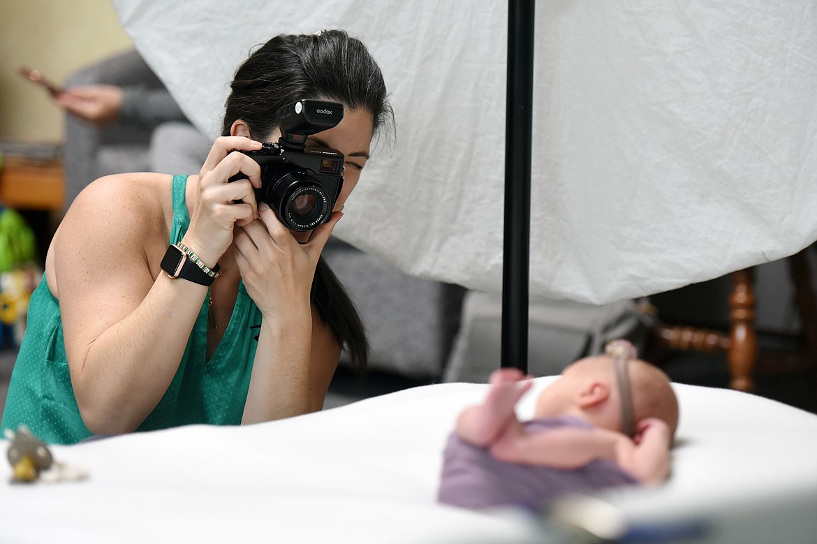 Photographer Dianne Dotter works with a newborn baby during a session at Kalispell Regional Medical Center on Tuesday, May 7. (Casey Kreider/Daily Inter Lake)