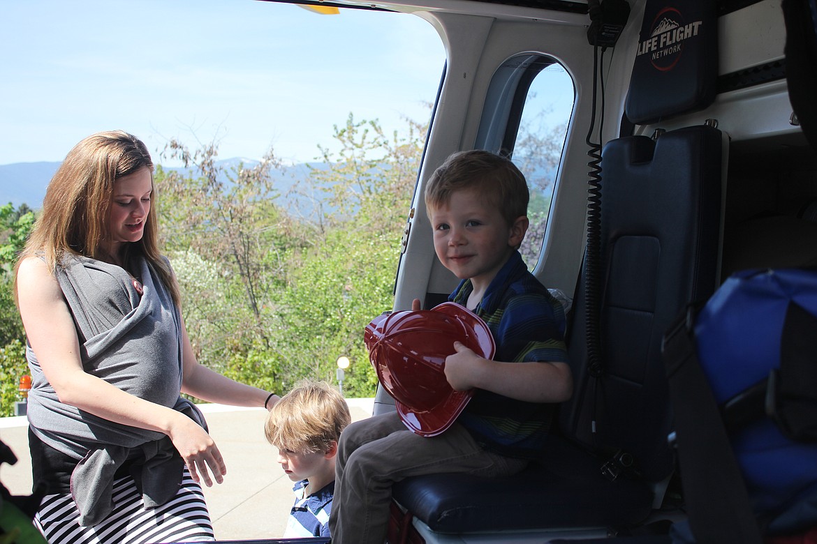 Photo by TANNA YEOUMANS
Dennis Geyman, son of Taylor and Amie Geyman, happily sat in the helicopter, while mom stood close by.