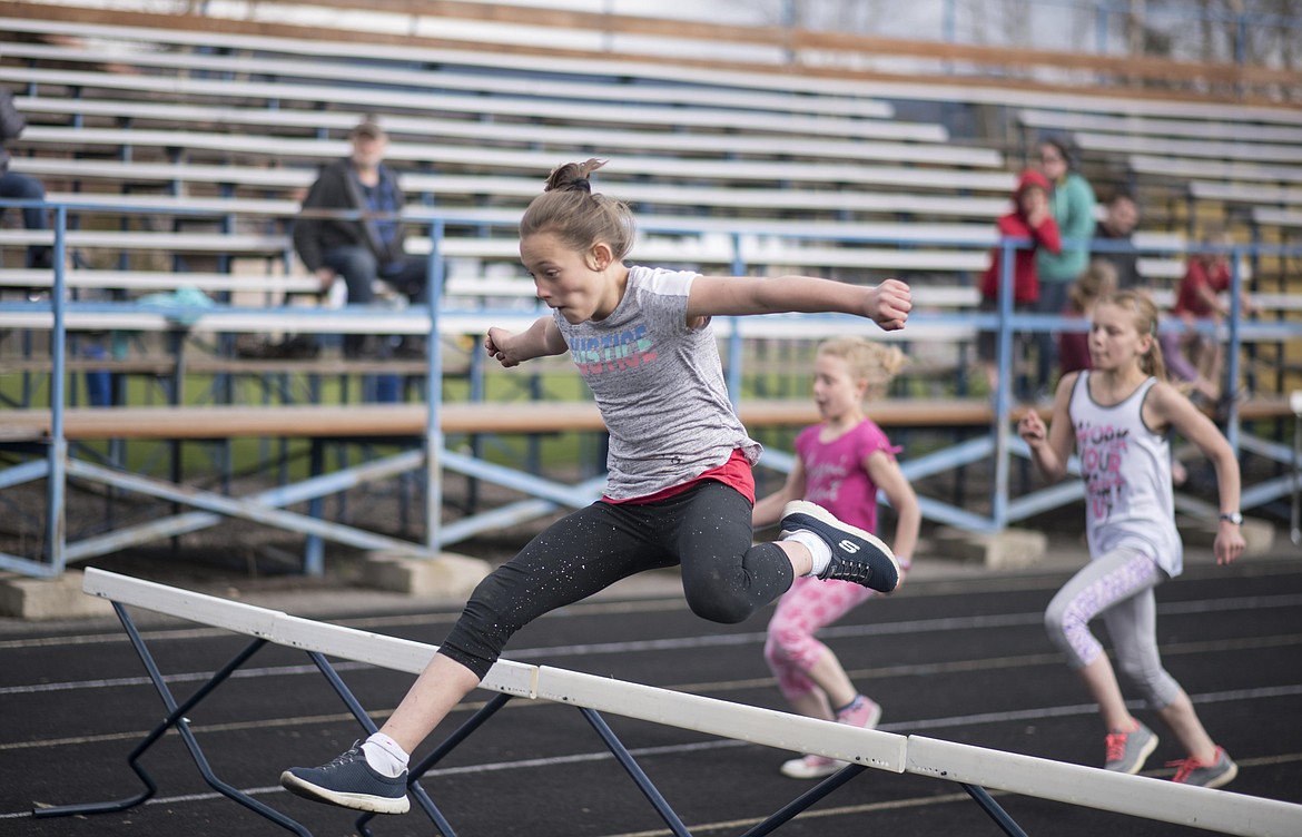 Grace Webber, 4th grade, jumps over a hurdle during the 4th and 5th grade Mini Meet, Thursday, May 2 at the Libby High School. (Luke Hollister/The Western News)