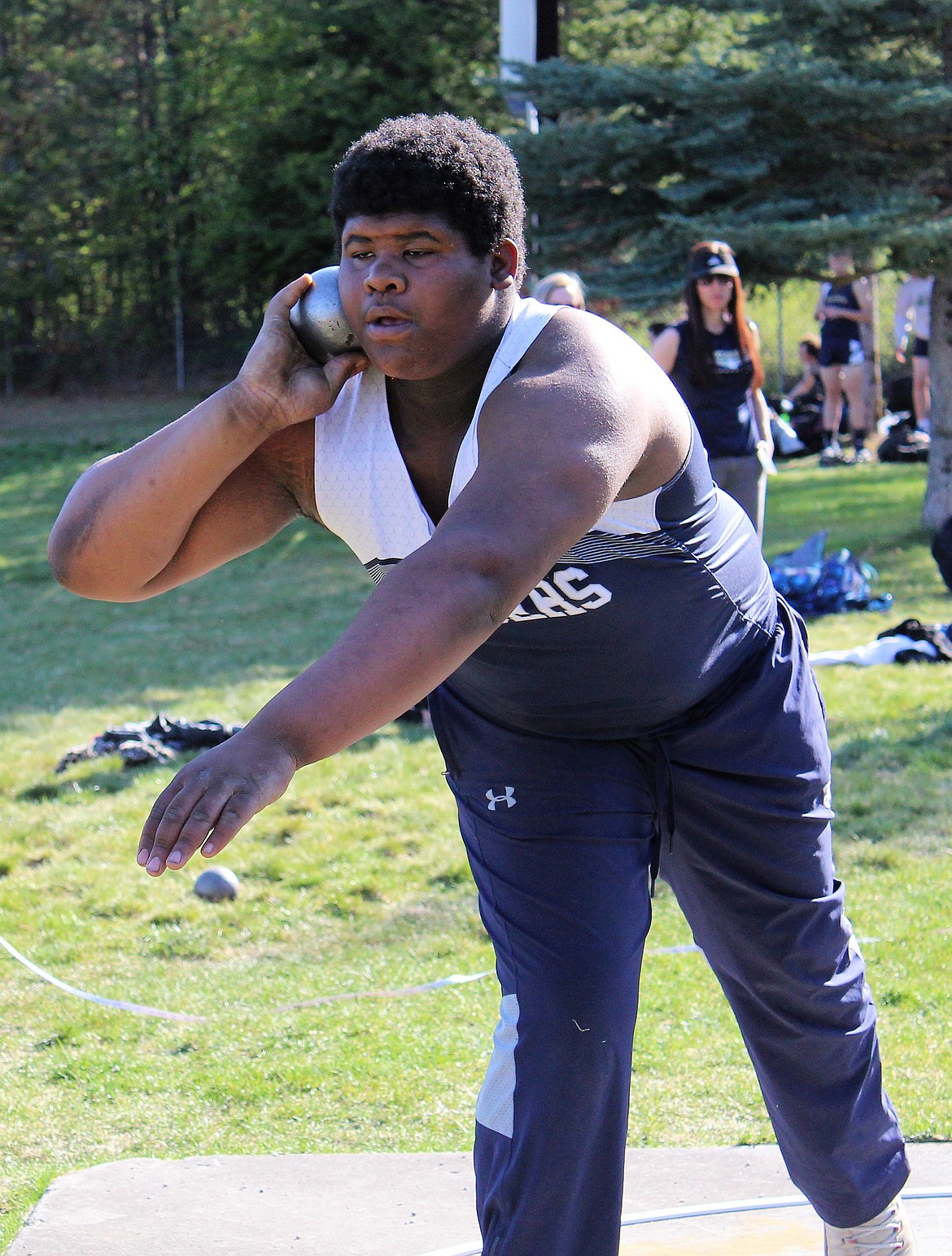 Photo by TERESA RAE 
Quinn Tucker throwing shotput.