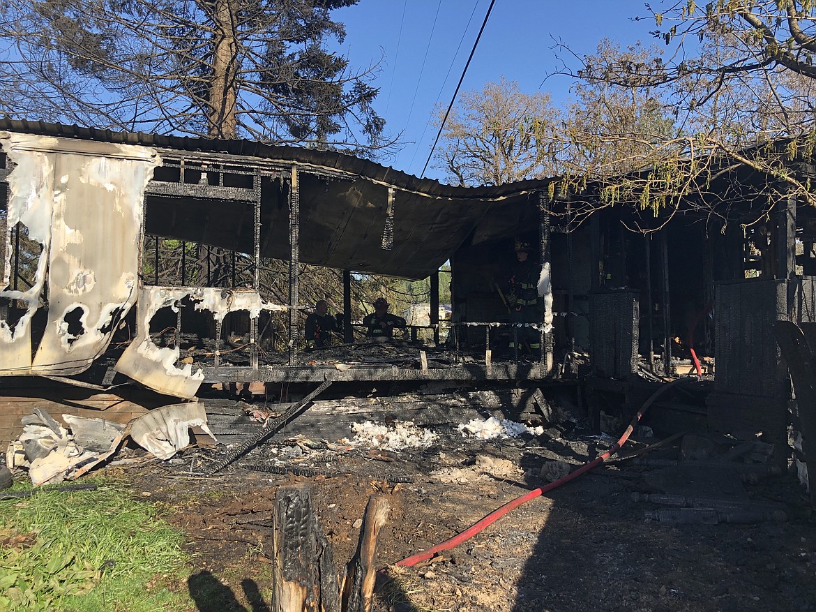 Photo by JOSH MCDONALD/ 
Firefighters with SCFD No. 2 survey the fire damage of the trailer on Oak and Silver Valley Road in Kingston after extinguishing the blaze on May 10.