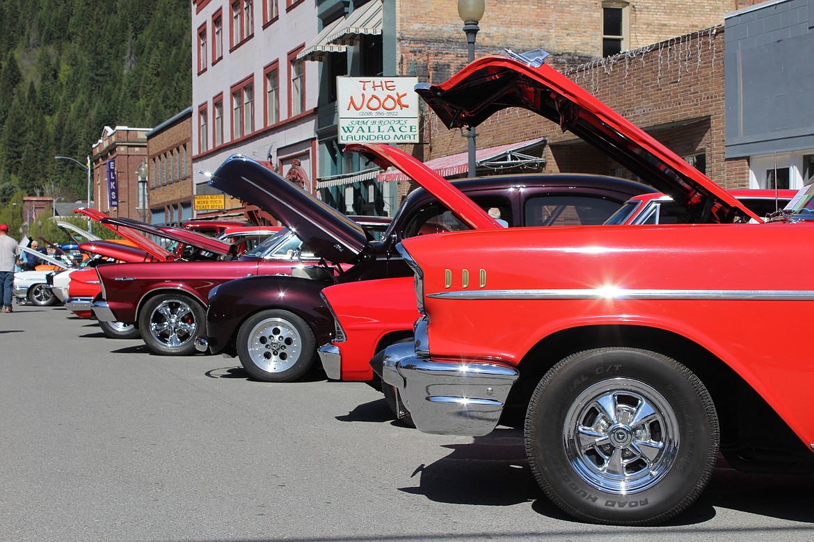 Some shiny red cars display on Cedar Street.