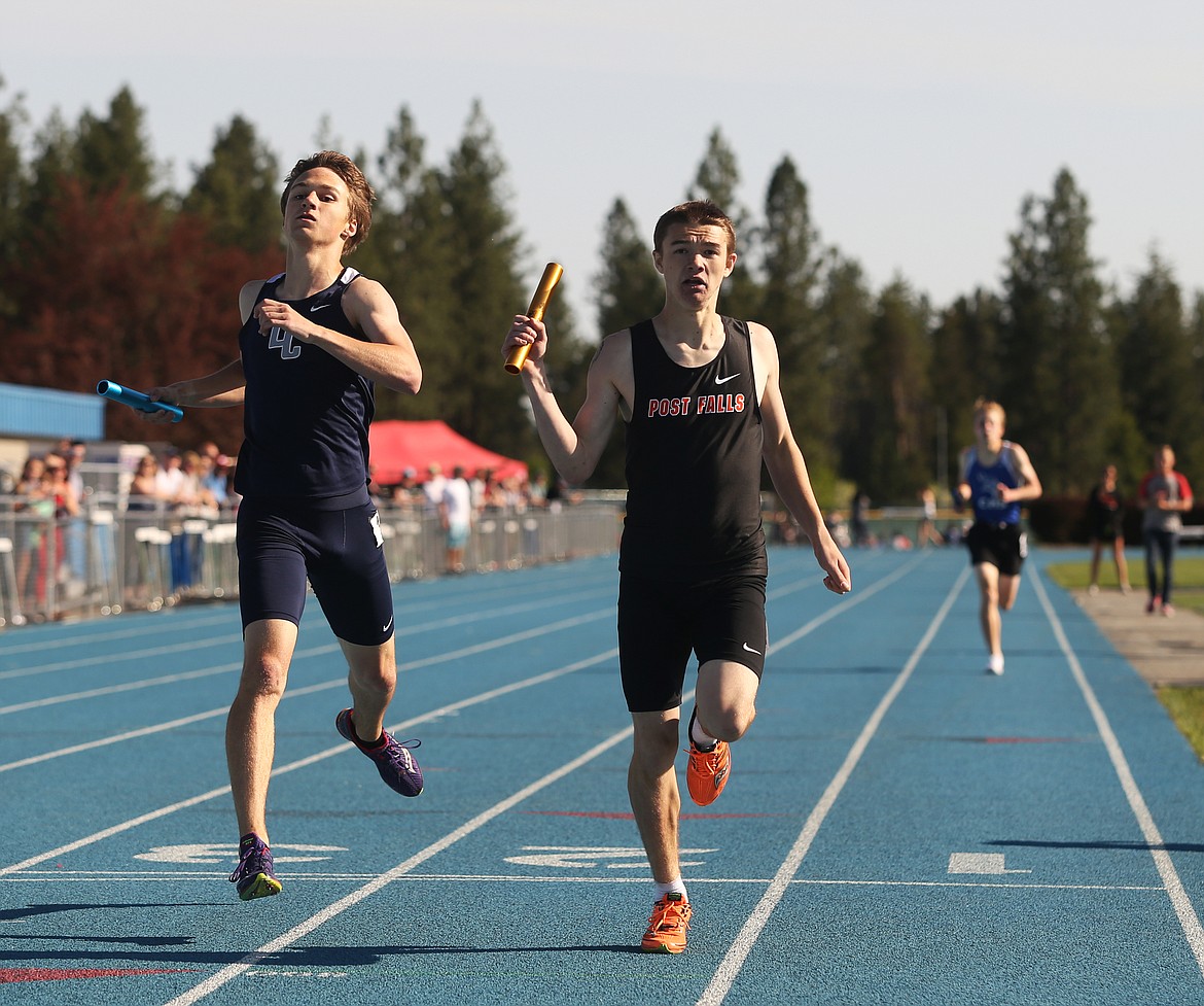 Post Falls' JJ Magill crosses the finish in first place a stride ahead of Lake City's Carter Gordon in the 4x800 meter relay. (LOREN BENOIT/Press)